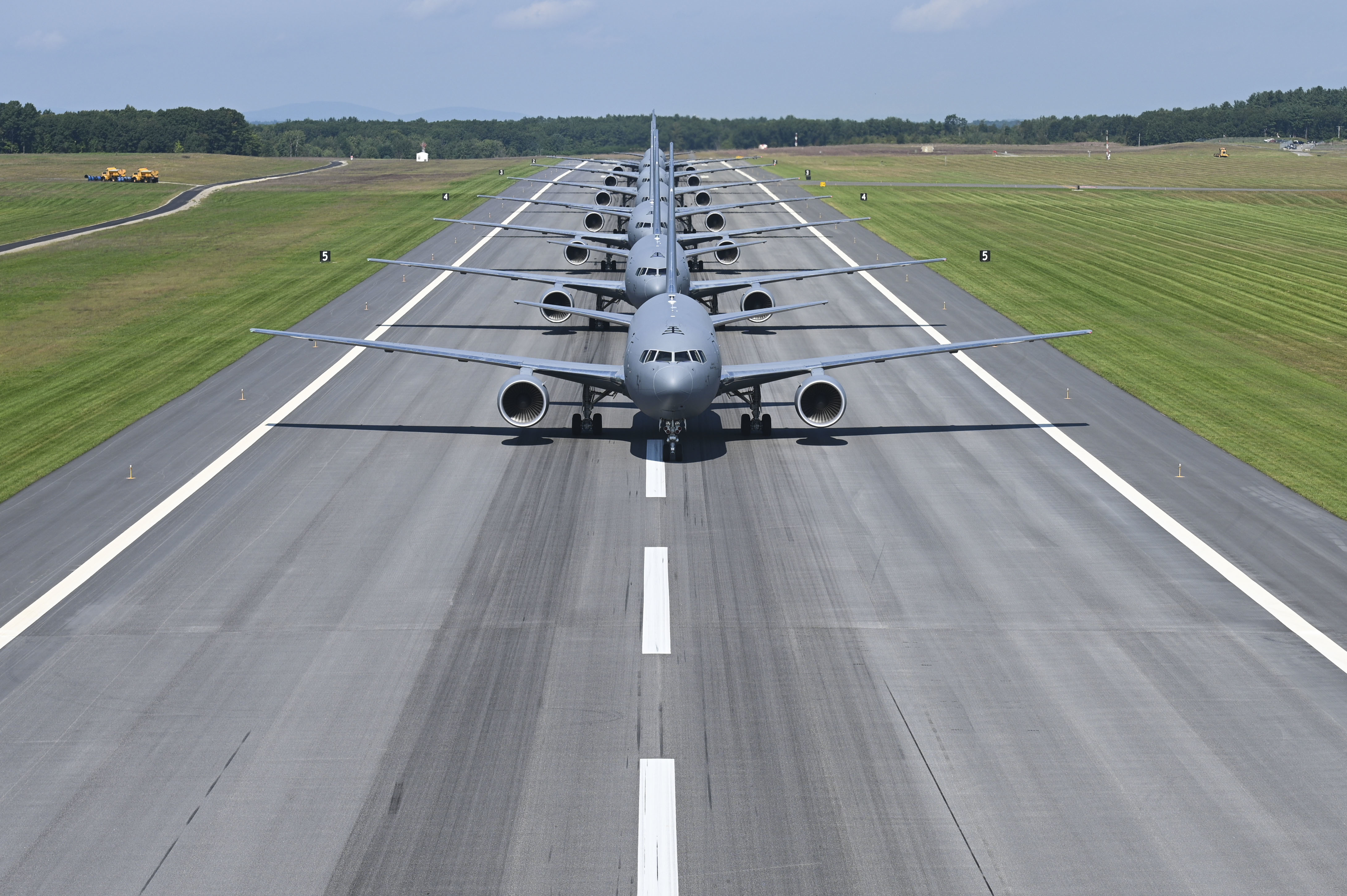 Image of KC-135 air refueling tanker flying with two A-10 fighter airplanes flying behind.