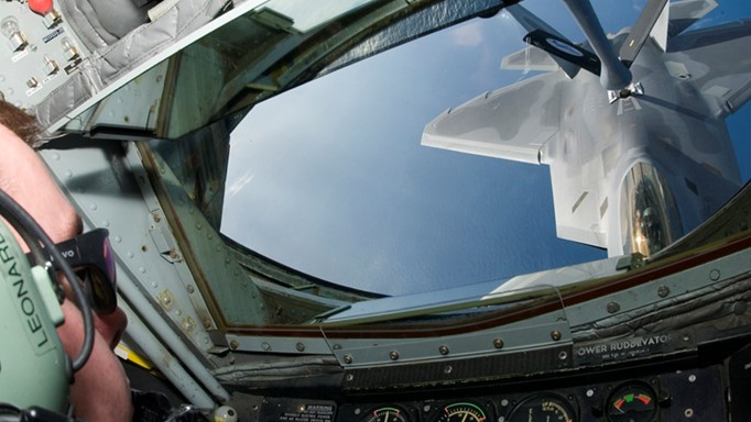 Photo of F-22 fighter being refueled by a KC-135 air refueling tanker