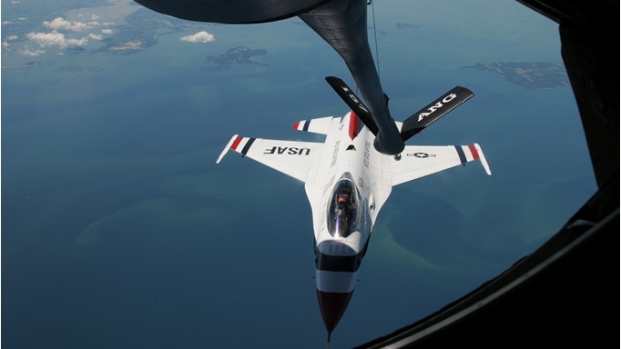 Image of U.S. Air Force Thunderbird F-16 fighter airplane being refueled by a KC-135 air refueling tanker